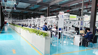 OEM apparel manufacturing — garment factory production line with workers